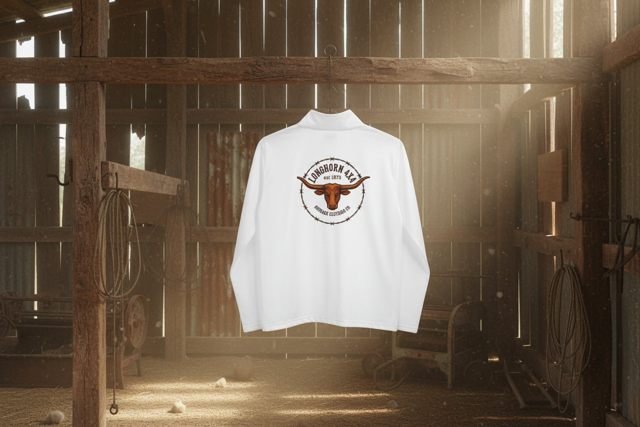 White long-sleeve shirt with a logo on the chest against hanging in an Australian woolshed background