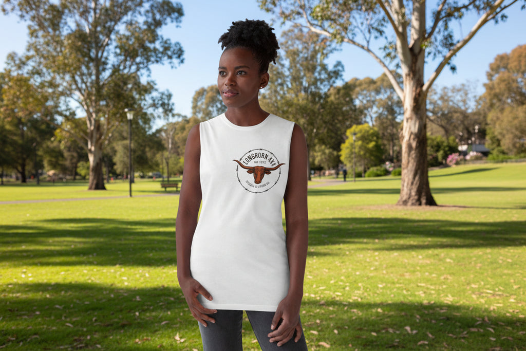 Woman wearing a white sleeveless shirt with a logo against a plain background