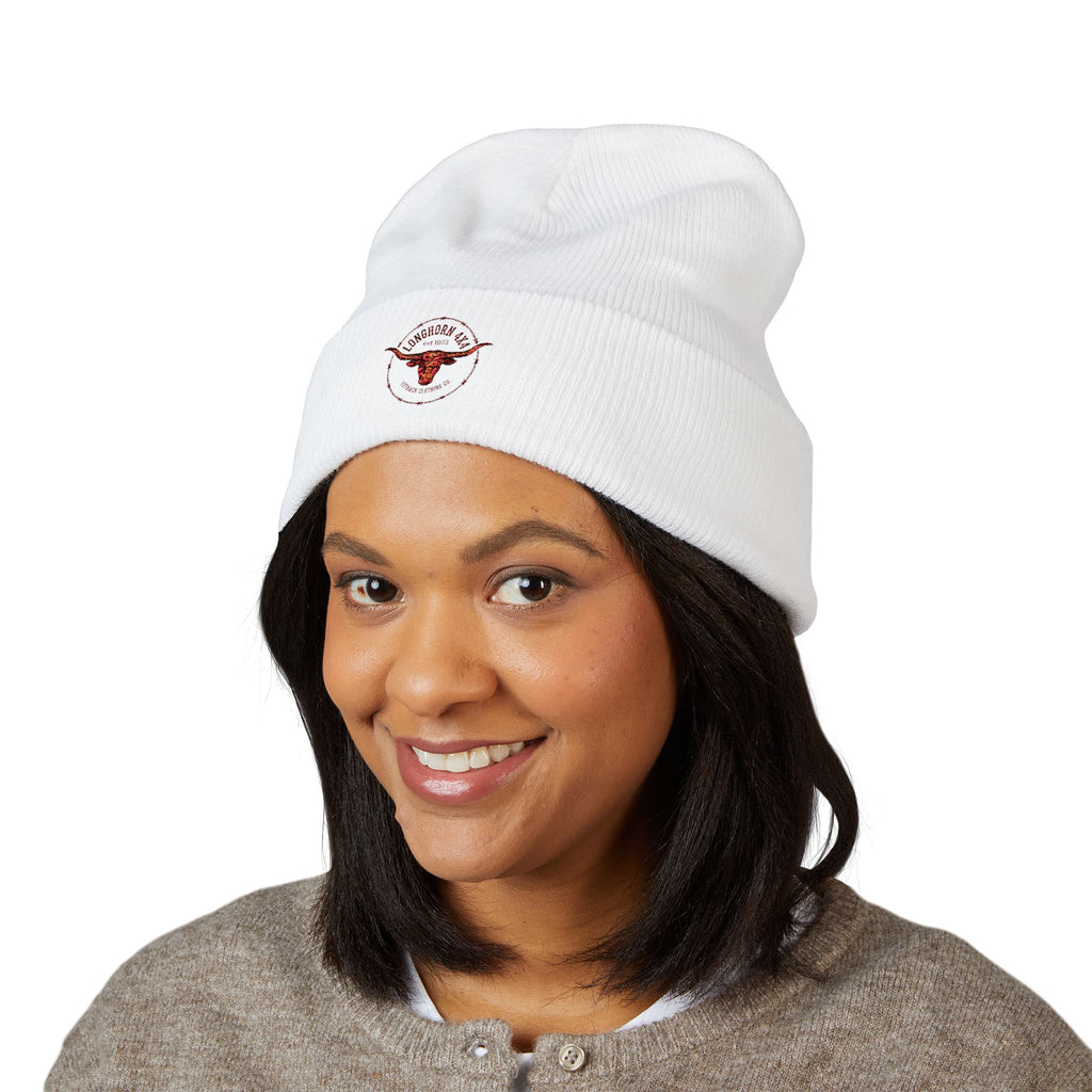 Person wearing a white beanie with a logo on a white background