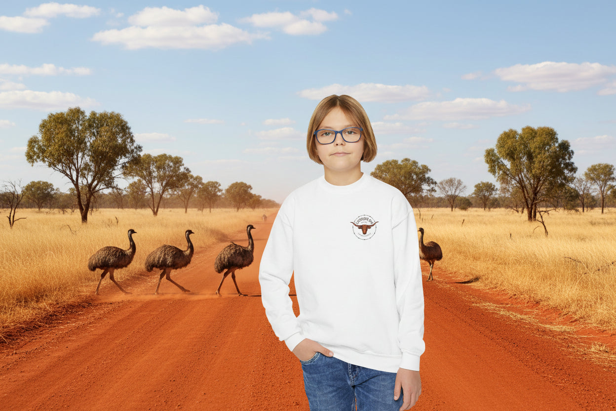Child wearing a white sweatshirt with a logo on an outback road with emus in the background