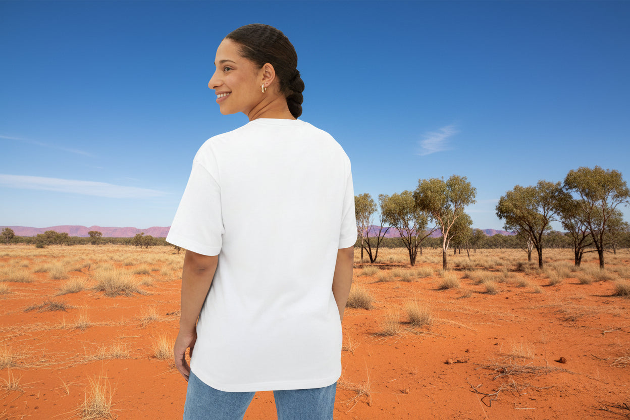Woman wearing a white t-shirt and blue jeans on a outback background