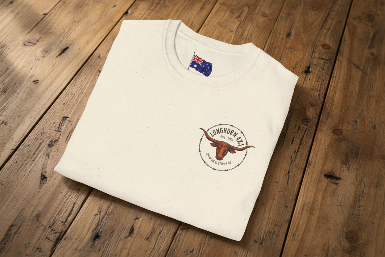 Folded cream-colored t-shirt with a logo and text on a rustic farmhouse table background