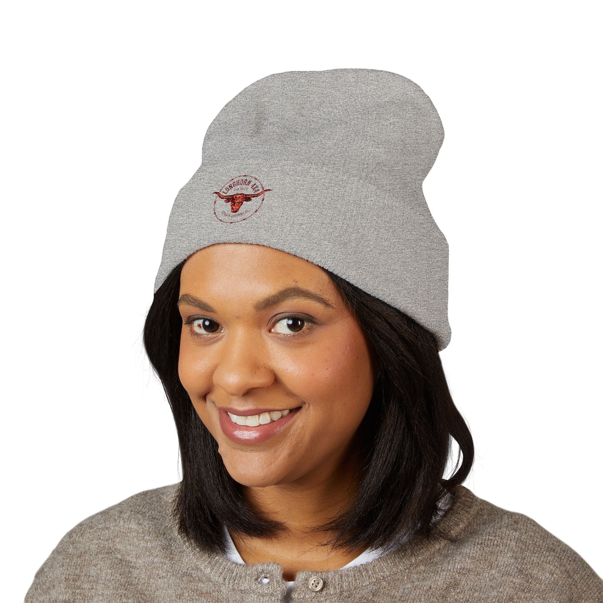 Woman wearing a gray beanie with a logo on a white background