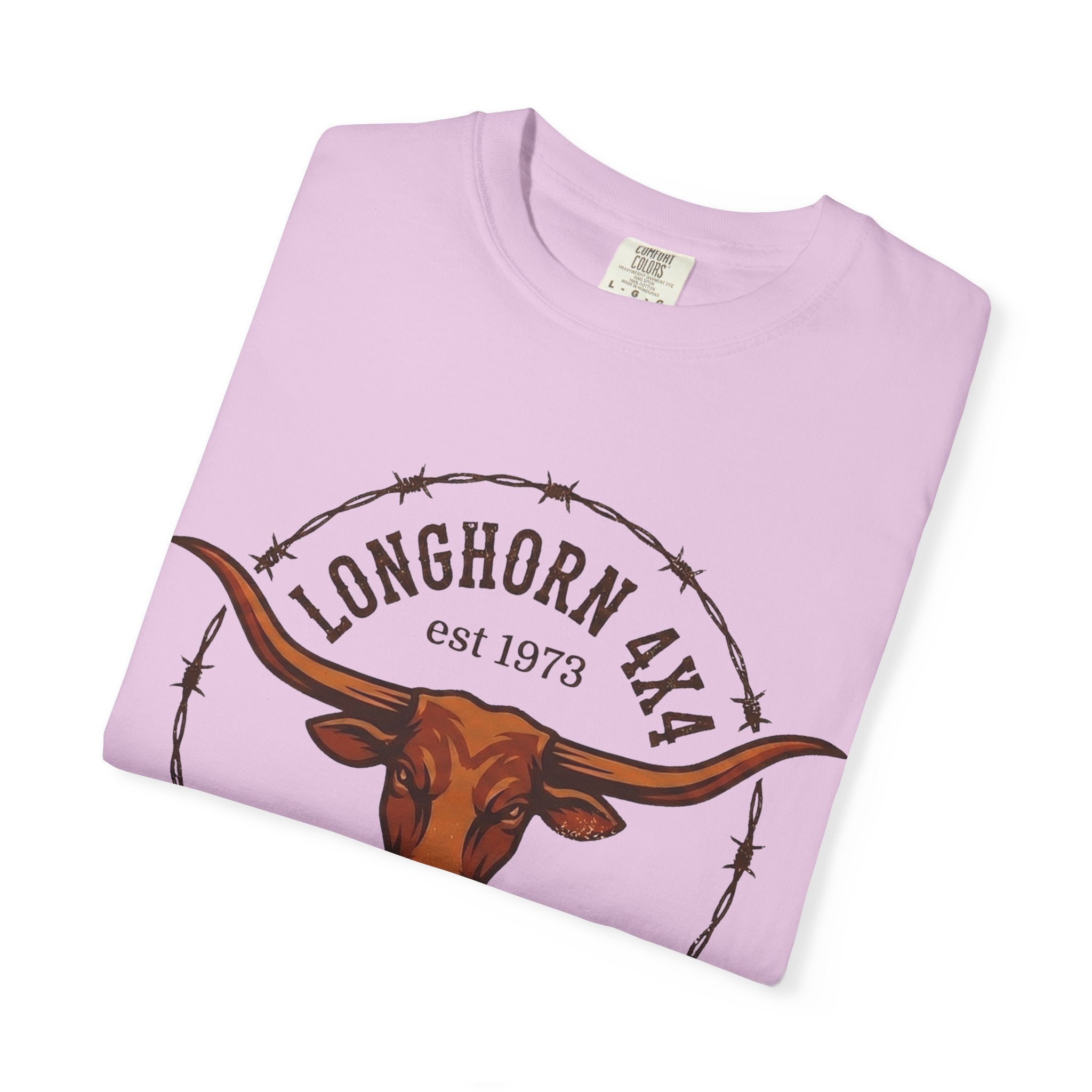 Folded pink t-shirt with longhorn and barbed wire design on a white background