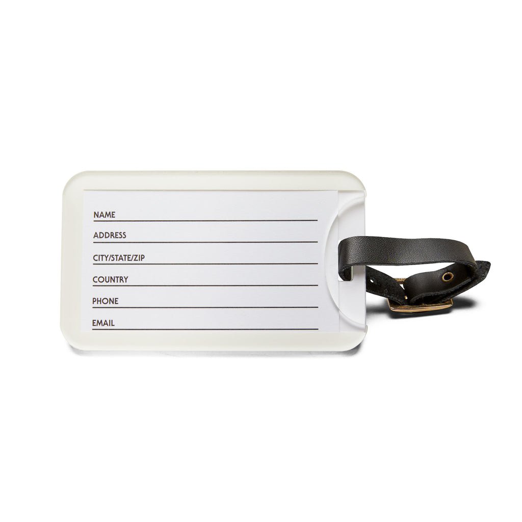 White luggage tag with black strap on a white background