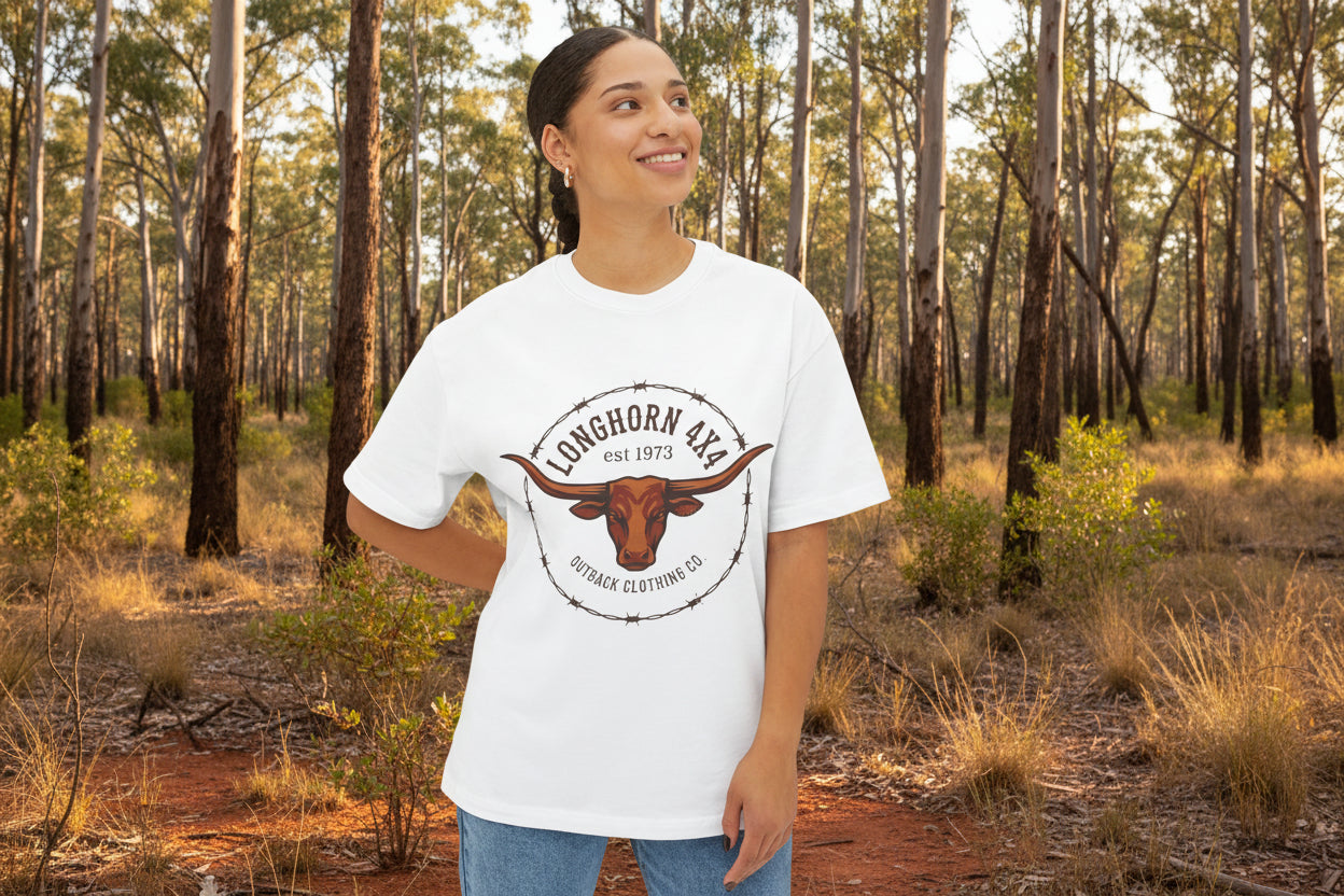 Person wearing a white t-shirt with a longhorn logo on an outback forest background
